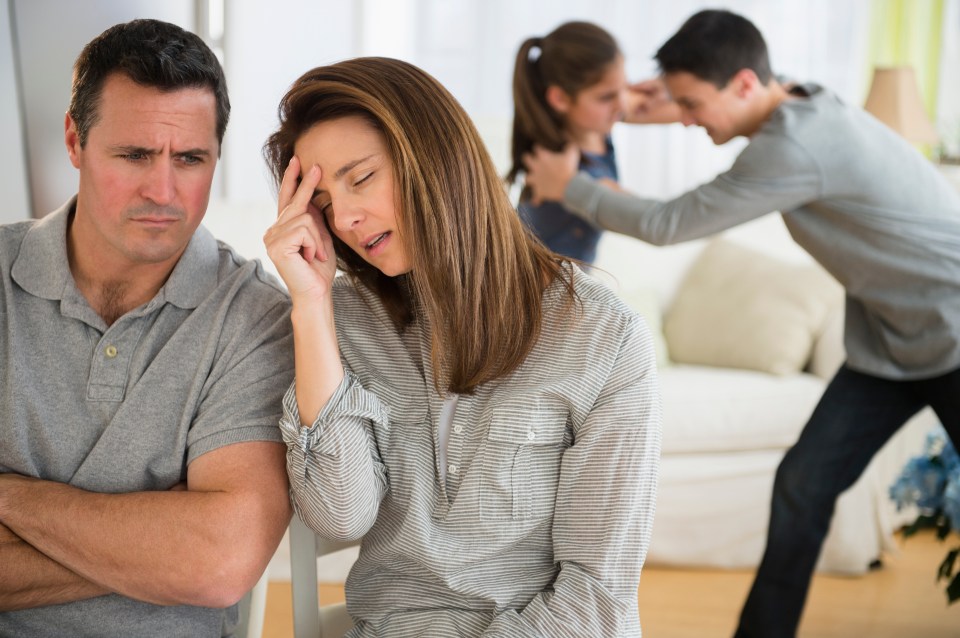 Frustrated Caucasian parents listening to children fight