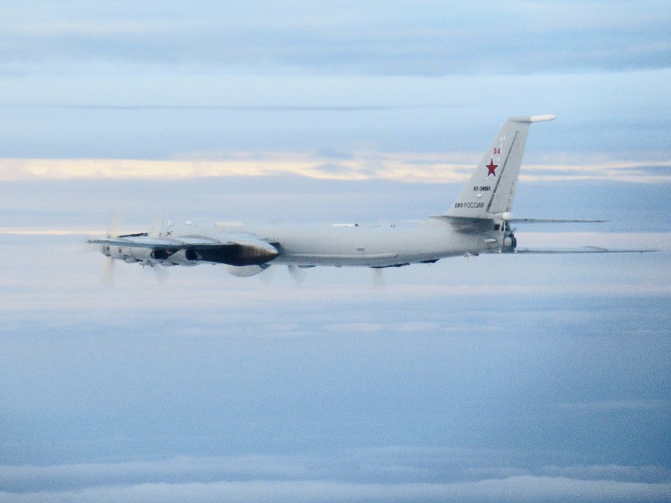 Pictures show the 'Bear' bomber flying close to the UK