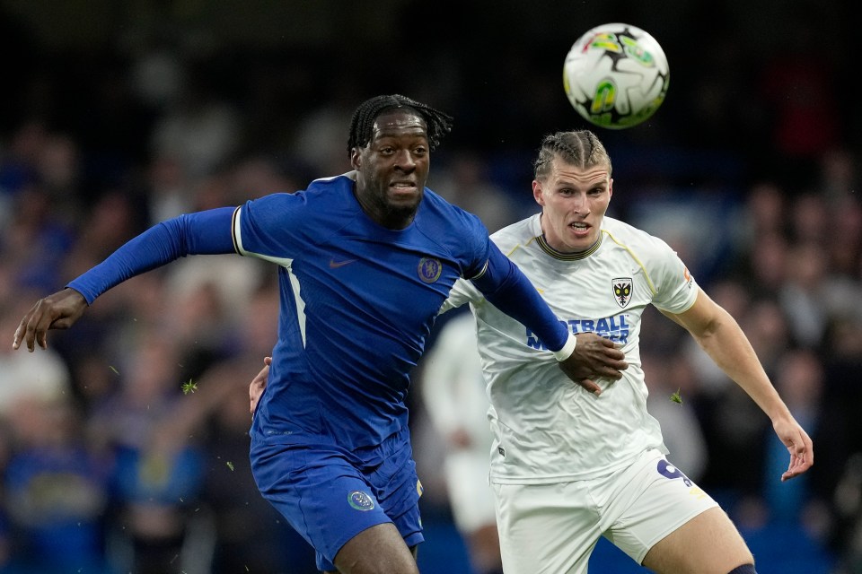 Wimbledon’s Josh Davison, right, challenges Chelsea’s Axel Disasi