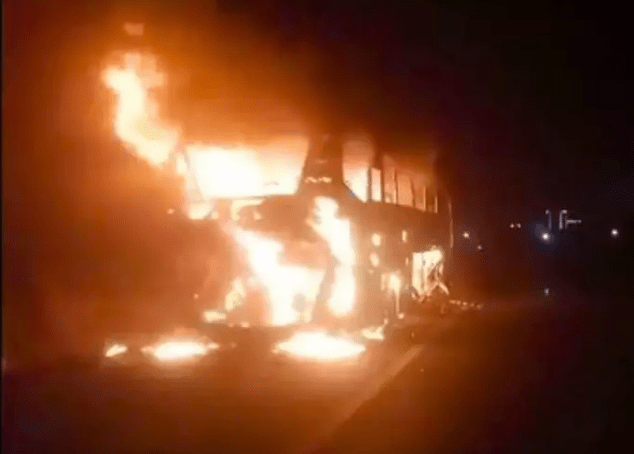 The bus could be seen burning after the crash in the early hours.