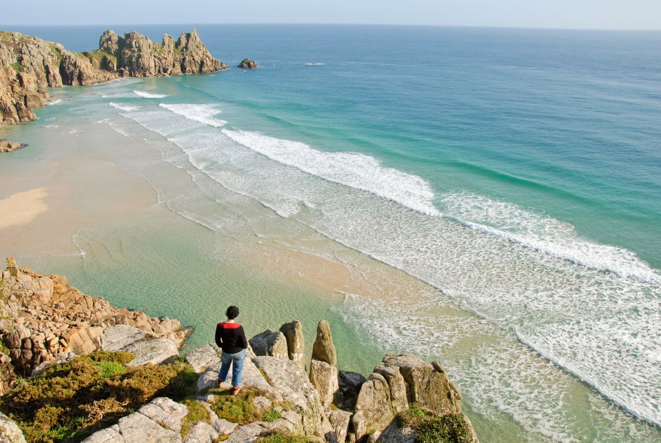 The beach is accessible via a climb down the cliffs behind the sand