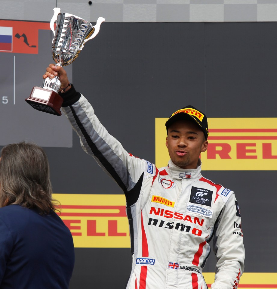 Jann Mardenborough celebrates on the winners' podium at the 2015 GP3 race in Sochi, Russia