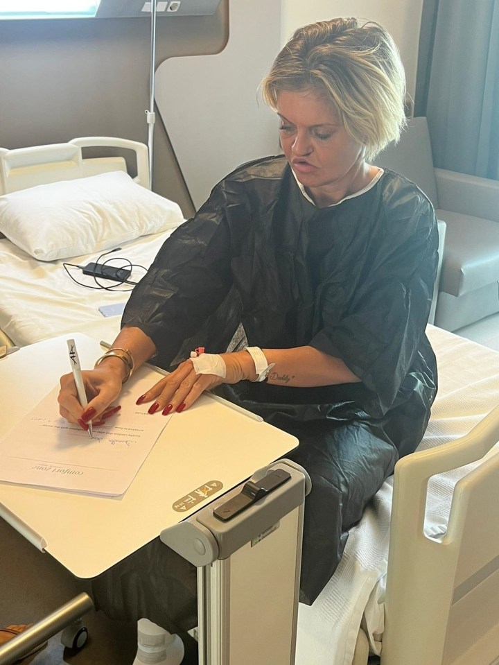 The star was pictured signing a document ahead of the surgery