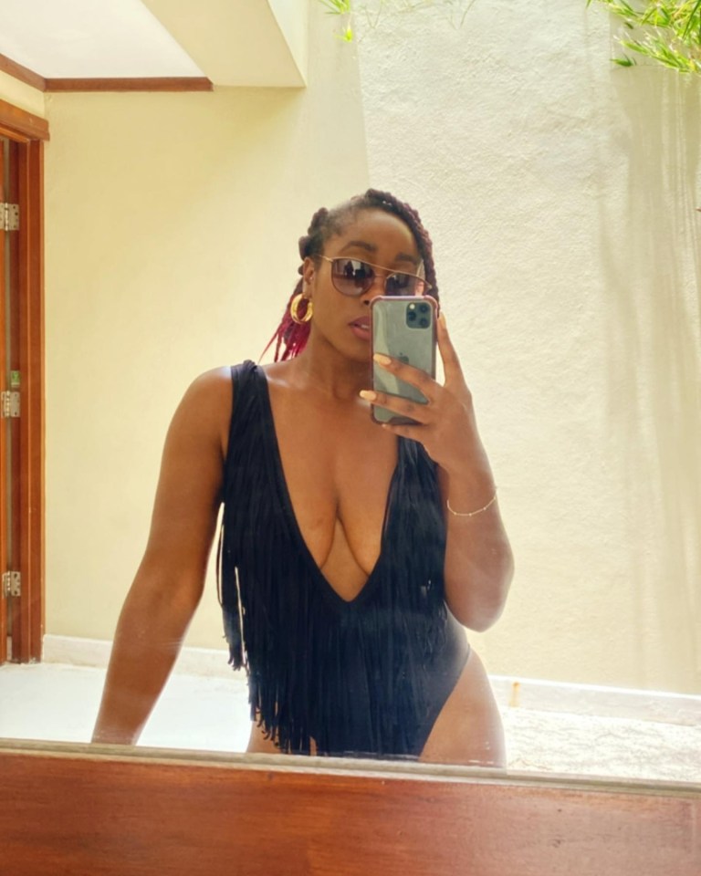 Scarlette set pulses racing as she snapped in a plunging black tasseled swimsuit