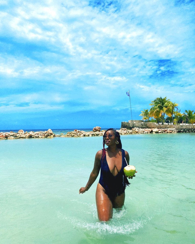 Scarlette is seen enjoying a refreshing coconut in the clear water