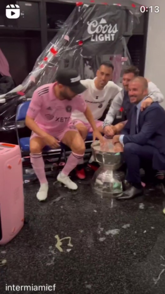 Owner David Beckham braved the bubbly to get his snap with Lionel Messi and the cup