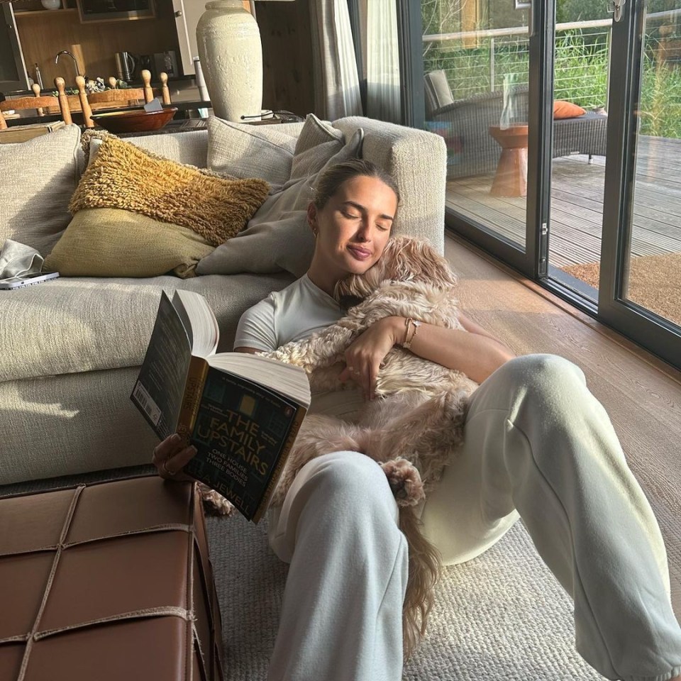 In the post was another snap of Sasha in which she is reading to her dog