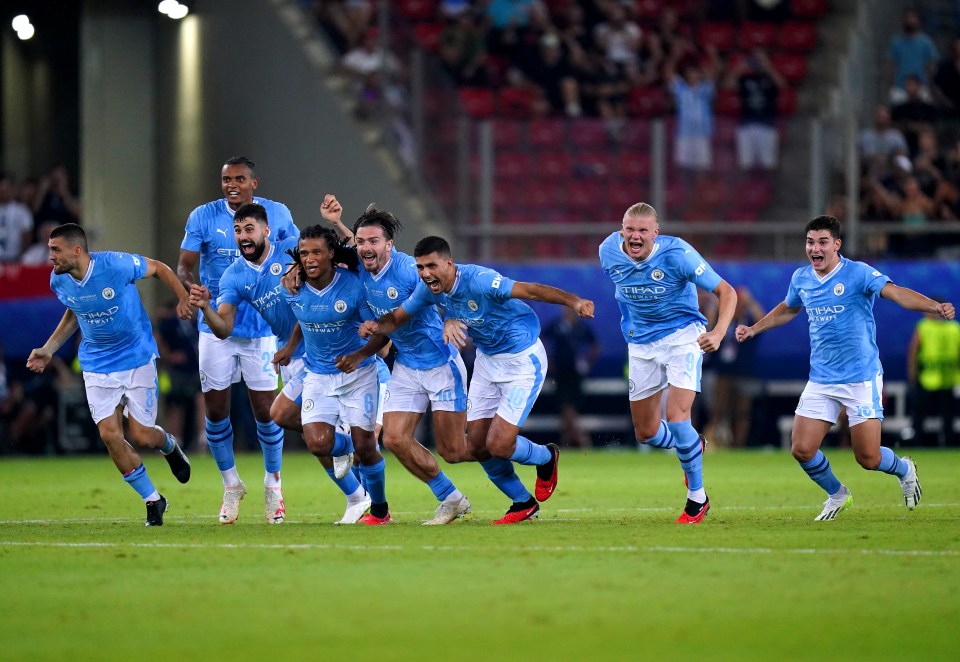 Manchester City players celebrate after winning the penalty shoot-out