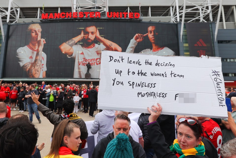 A woman protesting outside Old Trafford