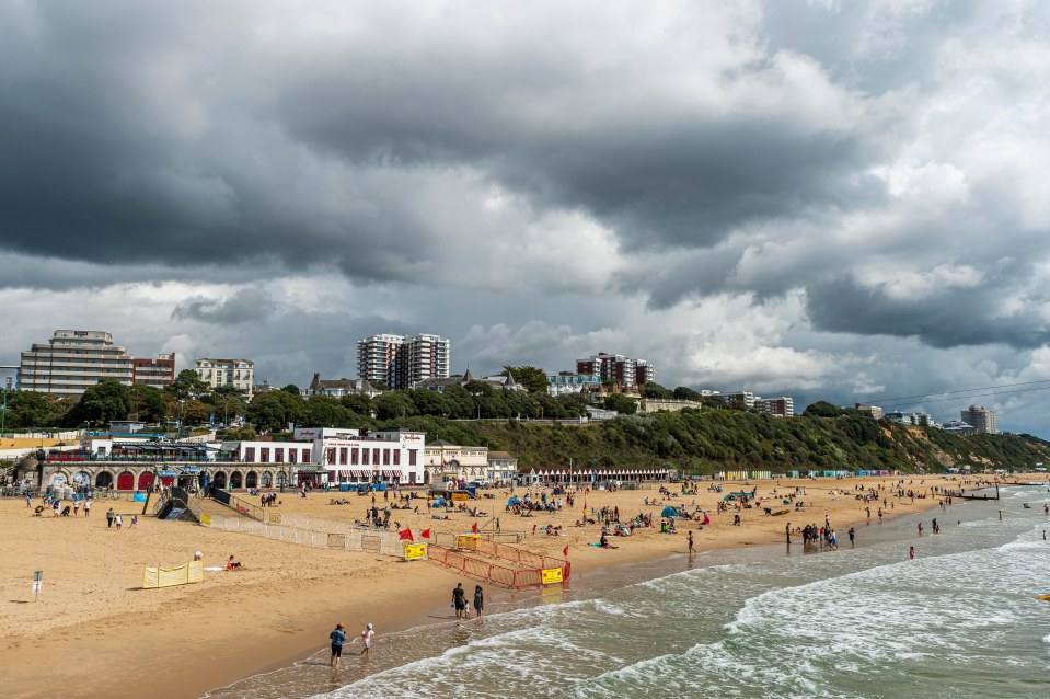 Dark clouds loom overhead at Bournemouth beach in Dorset