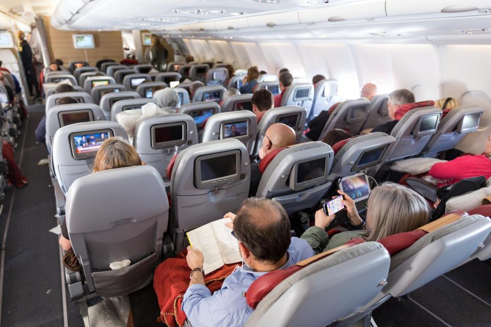 Passengers shouldn't pull the back of their seats when they stand up on planes