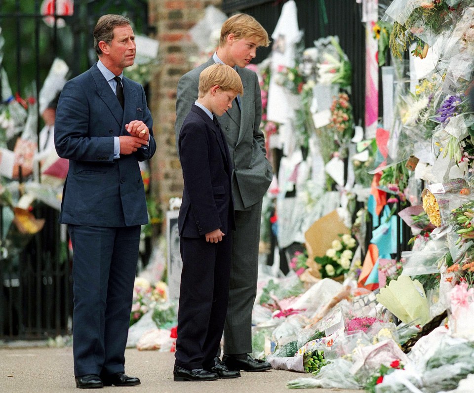 The King, Prince William and Prince Harry look at floral tributes to Diana outside Kensington Palace on September 5, 1997