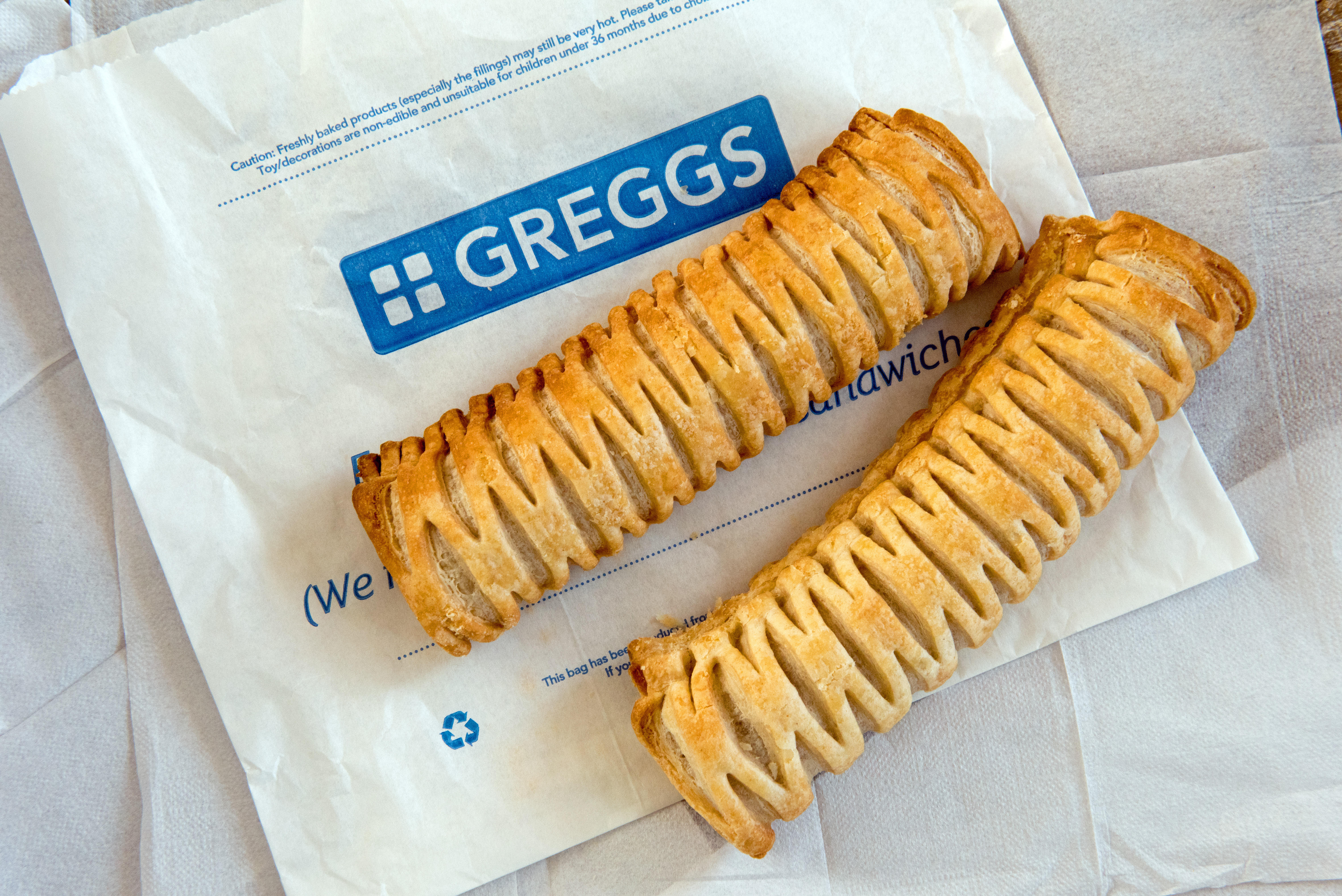 two pastries on a bag that says greggs on it