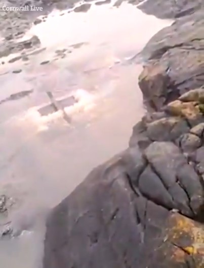 The video shows discoloured water from a storm overflow gushing out