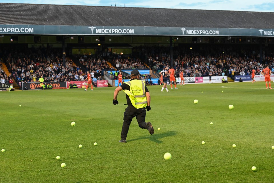 Southend's game against Eastleigh was delayed after fans hurled tennis balls onto the pitch