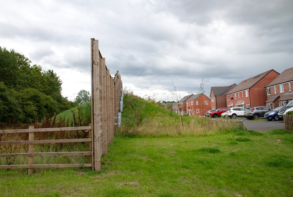 A wooden ‘acoustic barrier’ blocks out the noise of the motorway