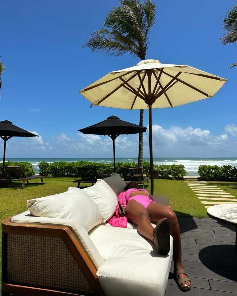 Naomi laid out on a sun lounger wearing a pink bikini