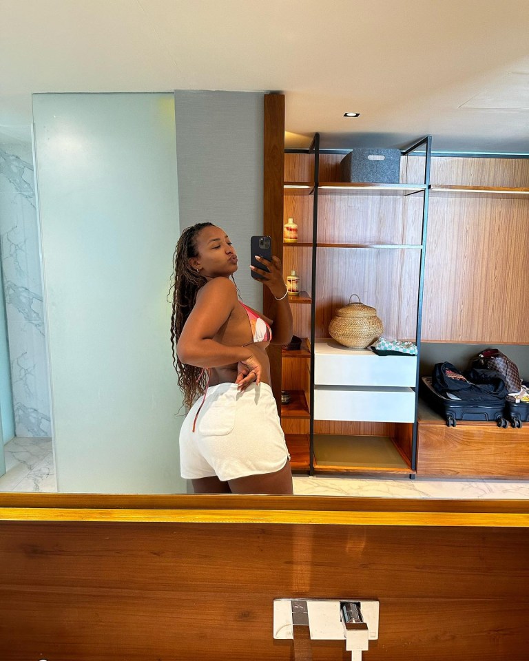 Naomi took a mirror picture wearing a bikini top and some white shorts