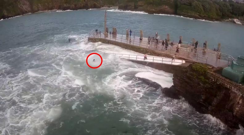 As she tried clinging onto the metal barriers, her panicked friends watched her be dragged away by the sea