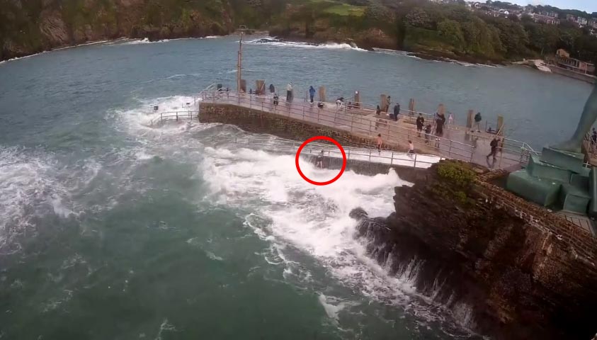 The high tide knocked the girl to her feet and threw her down the side of a wall