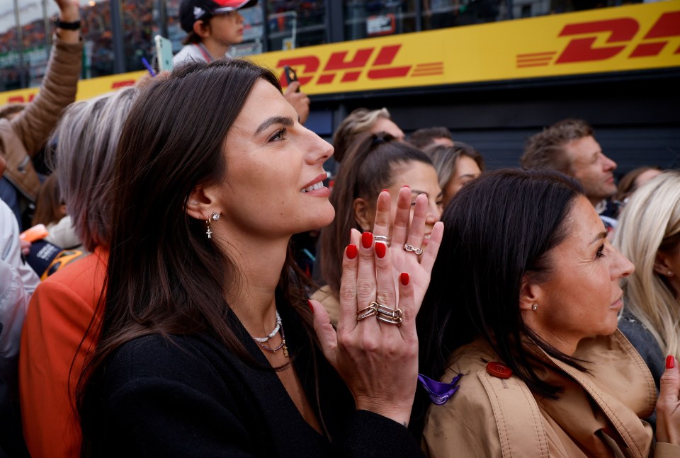 a crowd of people watching a race in front of a dhl sign