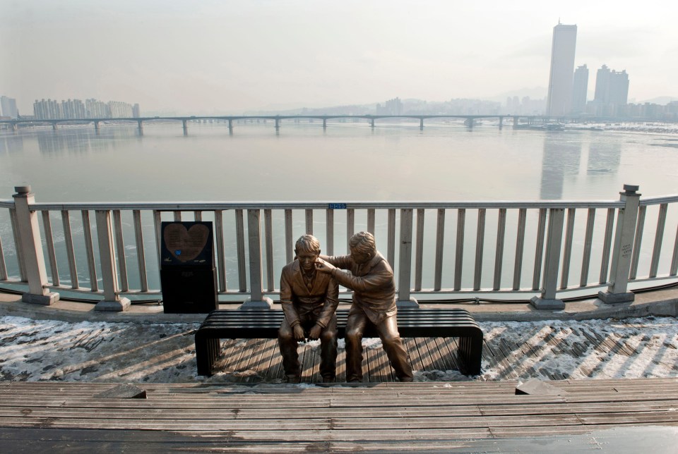 A statue of a man comforting a friend was installed in the bridge's first makeover