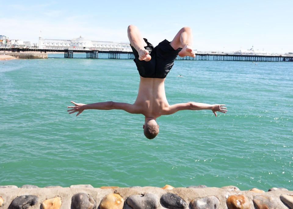 A youngster dives into the sea in Brighton today