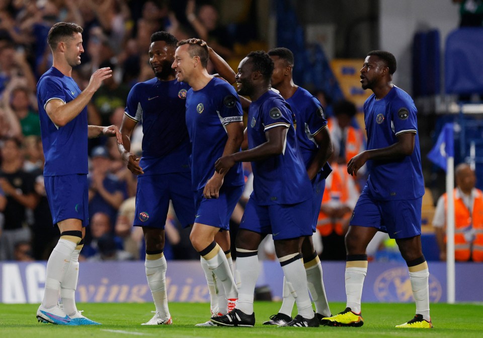 Terry (centre) was congratulated by team-mates including Gary Cahill, Michael Essien and Ramires