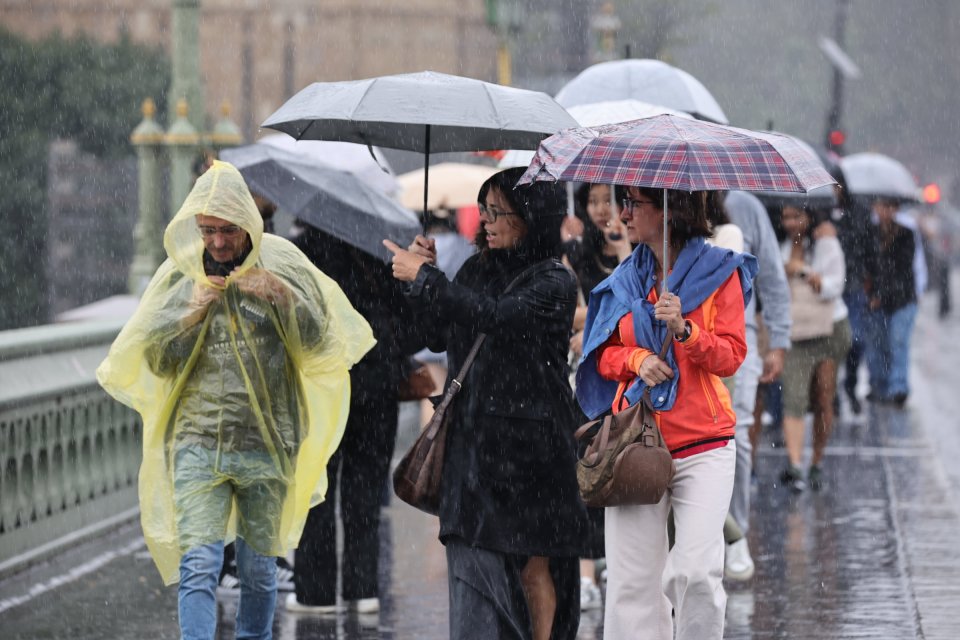 The rain bucketed down on Westminster Bridge in central London yesterday