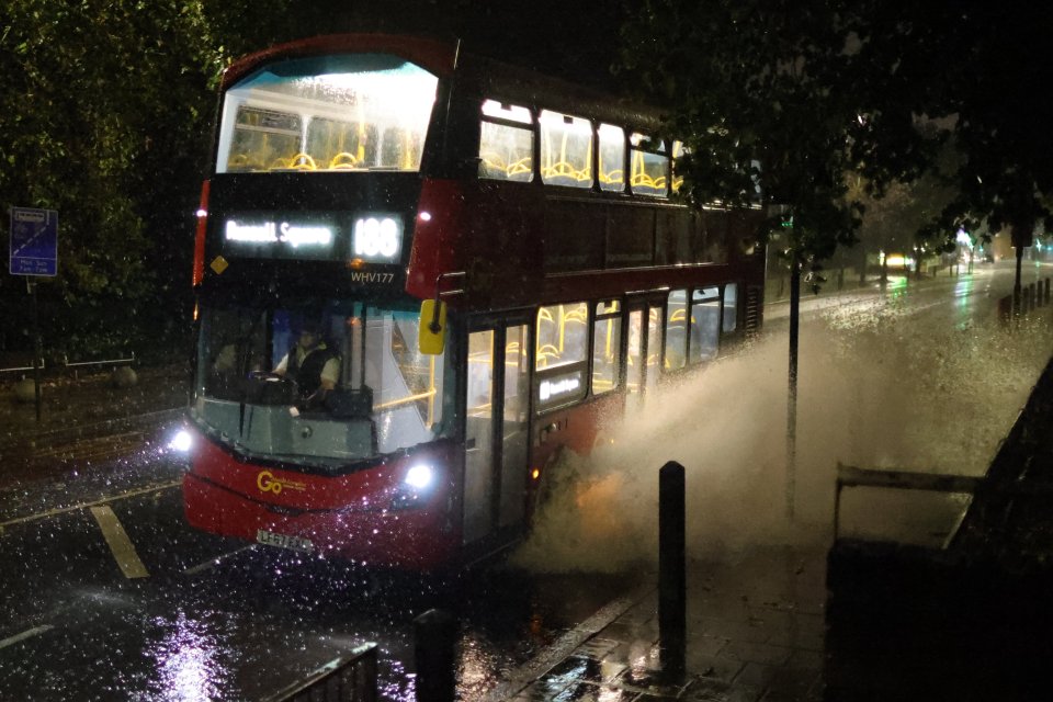 A bus makes its way through flooded roads in London's Greenwich last night