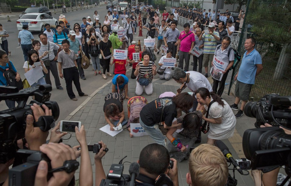 Families of the missing plane passengers protest outside the Malaysian Embassy in Beijing in 2015