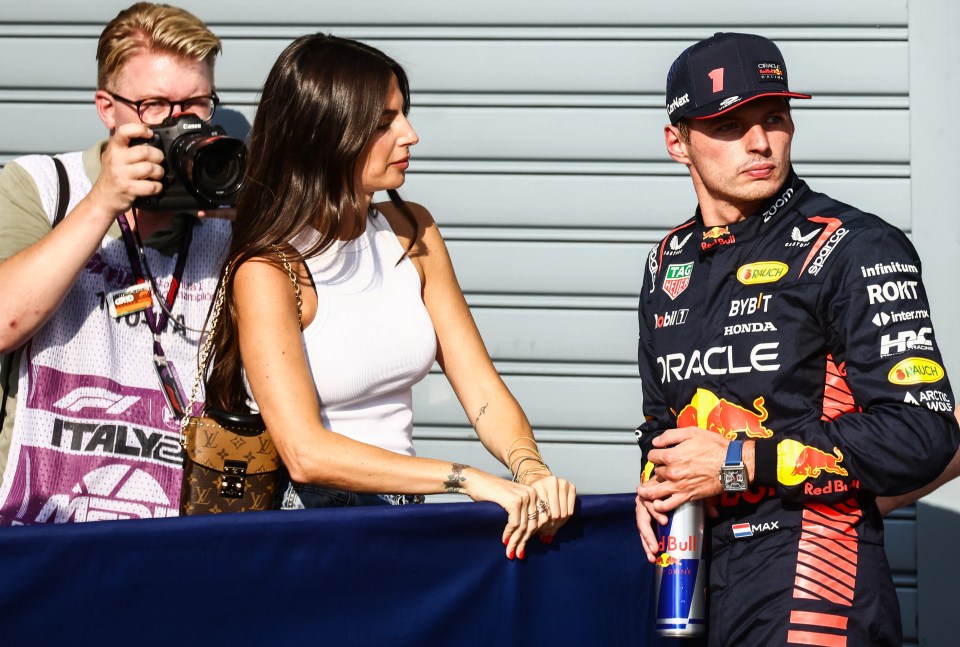 a man taking a picture of a man in a red bull outfit