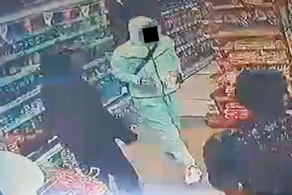 Two youths, both with hoods up, come into the shop