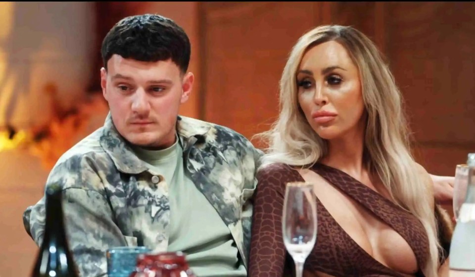 a man and a woman sit at a table with wine glasses