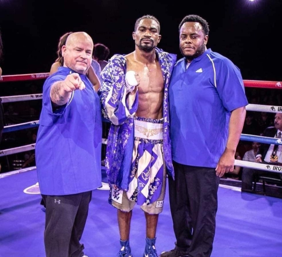 Julian smith, middle, with Rafael Ruiz, left, after winning a boxing fight