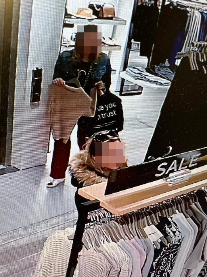 More CCTV footage shows a shoplifting suspect with a jumper in her hand