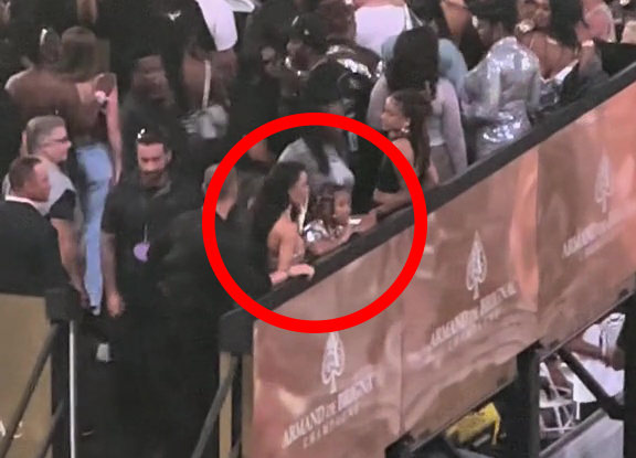 Kim K standing with daughter North, looking out over the crowd