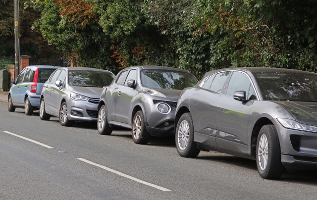 A row of defaced cars