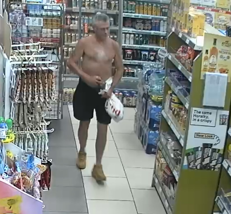 A shopper wearing a top appeared to put alcohol down his pants