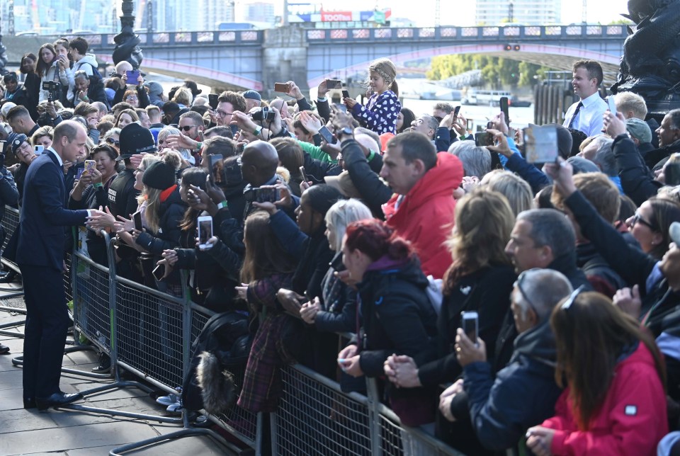 LONDON, 2022: Huge crowds are greeted by Prince William as they queue for miles to pay their respects to the late Queen