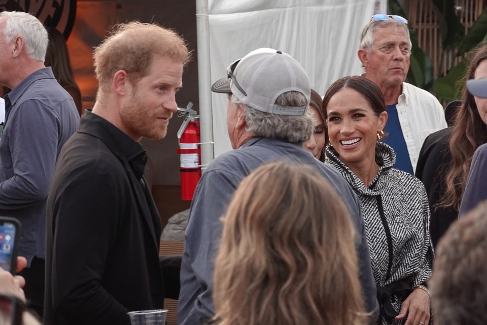 Meghan was seen beaming as she met guests at the event