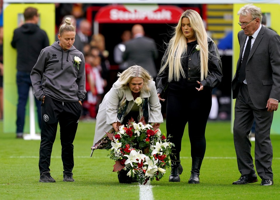 Former Sheffield United player Tony Currie, Sheffield United women’s Sophie Barker and Maddy Cusack’s mum and sister lay a wreath in memory of Maddy