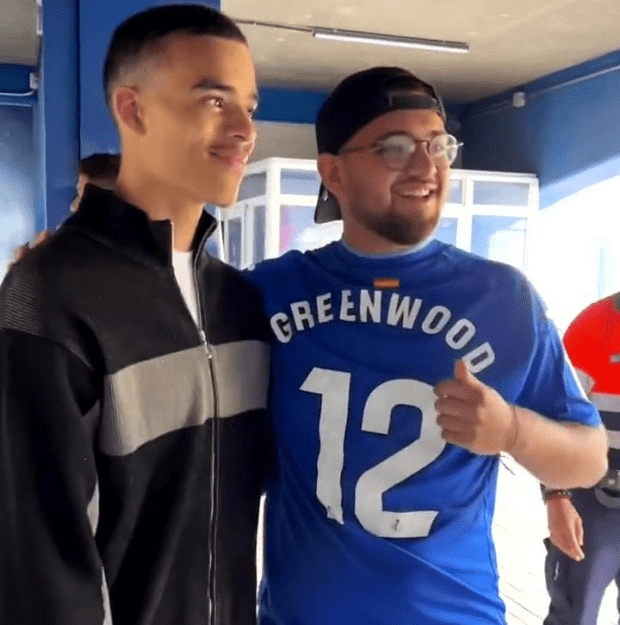 Greenwood posing for photos with fans who had already bought his shirt