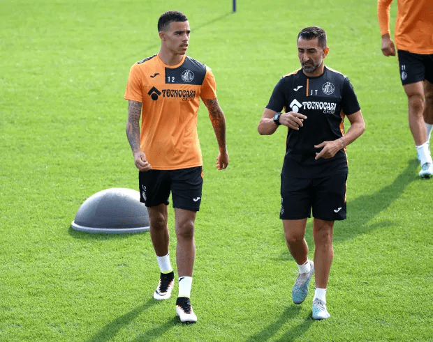 Greenwood listens intently to a Getafe coach