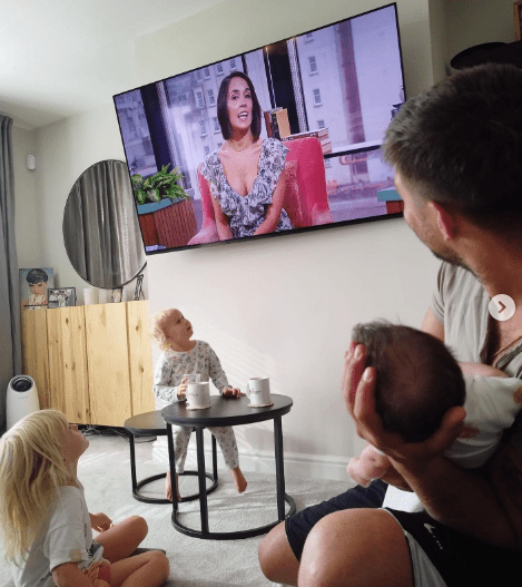 Her husband Aljaž Škorjanec held their daughter Lyra while they watched the TV