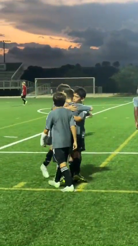 The youngster is mobbed by his team-mates