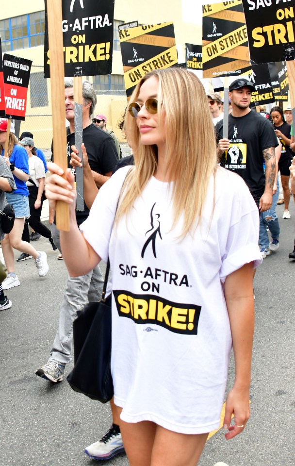 Margot Robbie marches during the rally