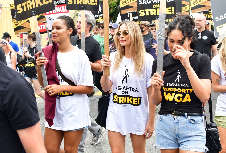 Margot Robbie marches from Netflix Studios to Paramount Studios during a SAG/AFTRA rally in West Hollywood