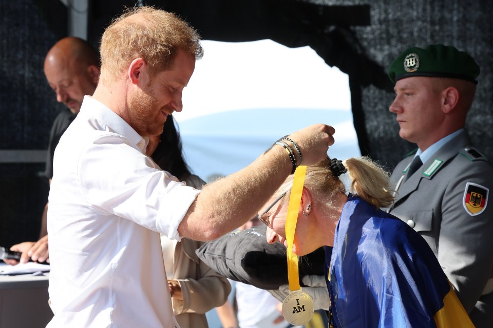 Harry helped present medals which said 'I Am'