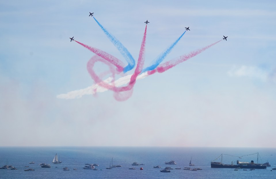 The RAF Red Arrows soar through the clear blue sky at the Bournemouth Air Festival yesterday